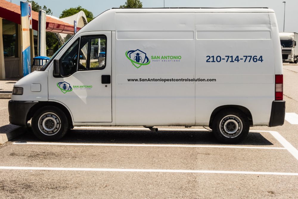 A white van in a parking lot, signifying a pest control service located in San Antonio, TX.